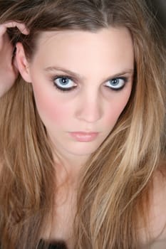 Beautiful female model with blue eyes and dark make up