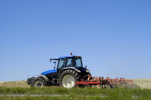 the harvest of colza with machines like a reaping-machine threshing-machine and tractor