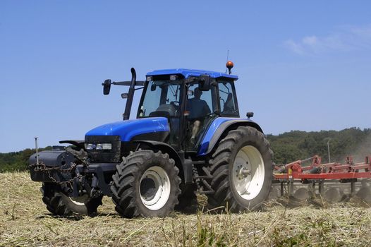 the harvest of colza with machines like a reaping-machine threshing-machine and tractor