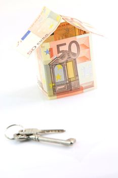 finance banking constuction and business concepts house with euro money and keys blur in front isolated on white background