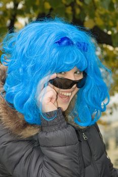 Laughing girl with wig and black glasses