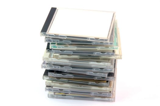 pile of cd cases isolated on white background and empty label to add your message