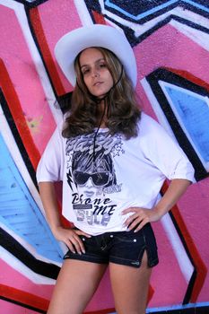 cowboy fashion girl in graffiti background