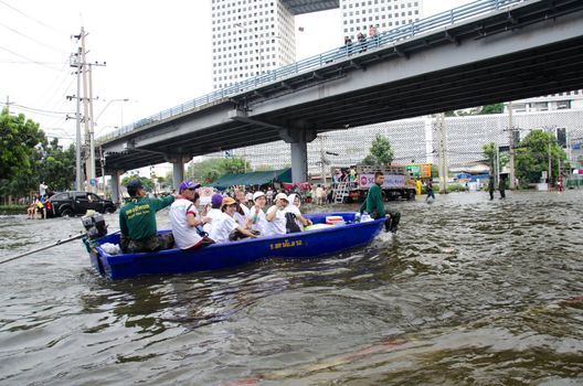 BANGKOK, THAILAND-NOVEMBER 13: Transportation of people in the streets flooded after the heaviest monsoon rain in 50 years in the capital on November 13, 2011 Phahon Yothin Road, bangkok, Thailand.