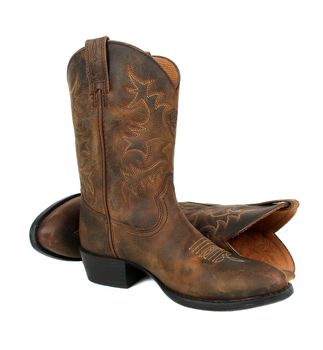Pair of brown leather cowboy boots on white background