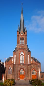 Roman catholic church against a blue sky in Wateringen, the Netherlands.