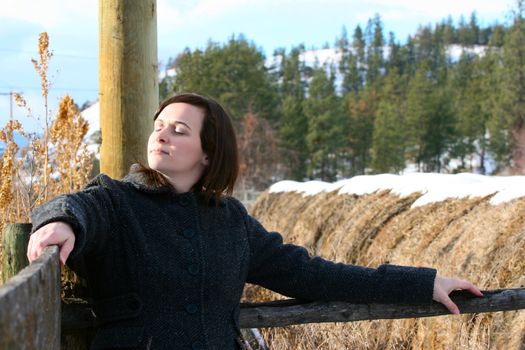 Beautiful brunette female taking in the winter scene