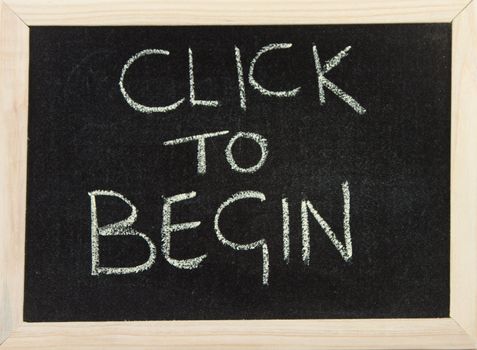 A black board with a wooden frame and the words 'click to begin' written in chalk.