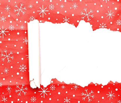 torn Christmas decorative paper over wood background