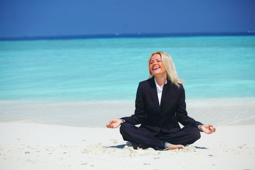 yoga business woman in lotus pose on the beach