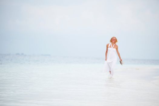 woman in a white dress on the ocean coast