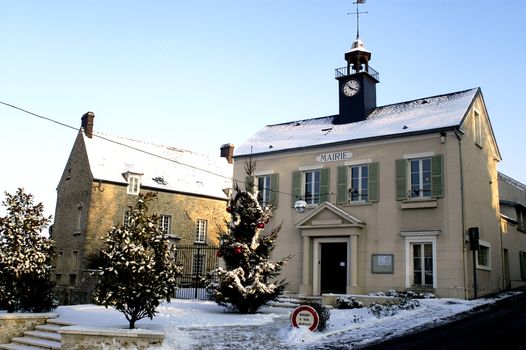 Town hall of Thoiry in winter under snow