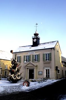 Town hall of Thoiry in winter under snow