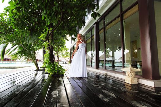 woman in a dress on a bridge home sea