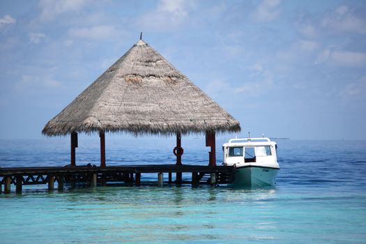 resort maldivian houses in blue sea