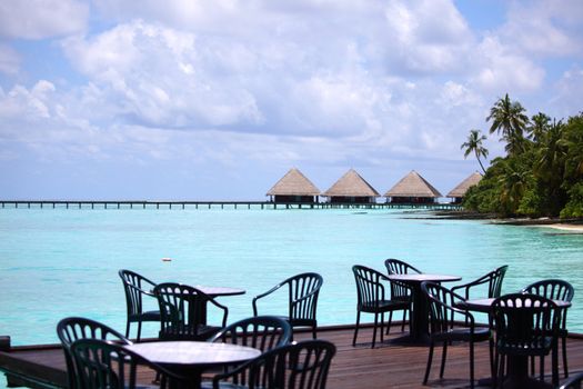 resort maldivian houses in blue sea