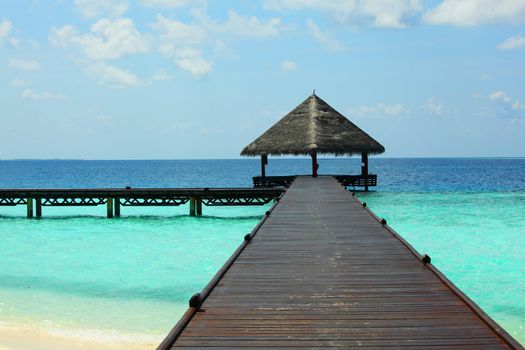 resort maldivian houses in blue sea
