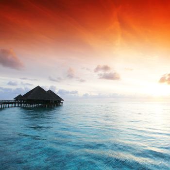 resort maldivian houses on sunrise