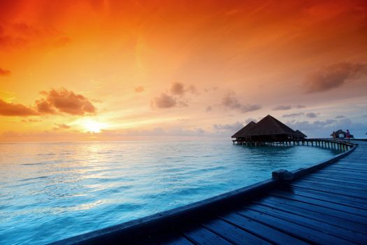 resort maldivian houses on sunrise