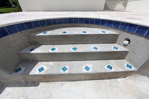 The steps of a swimming pool under construction.