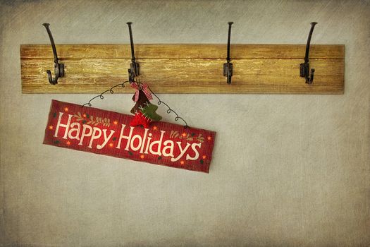 Wooden holiday sign on antique plaster wall