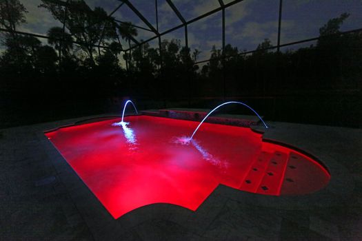 A Swimming Pool lit up at Night