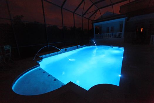 A Swimming Pool lit up at Night