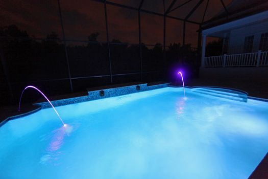 A Swimming Pool lit up at Night