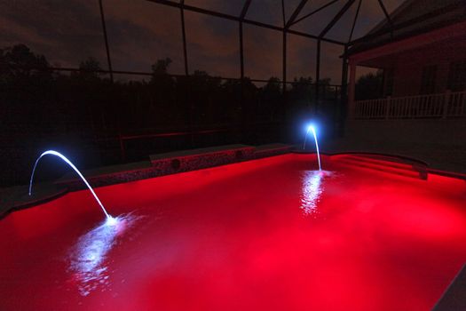 A Swimming Pool lit up at Night