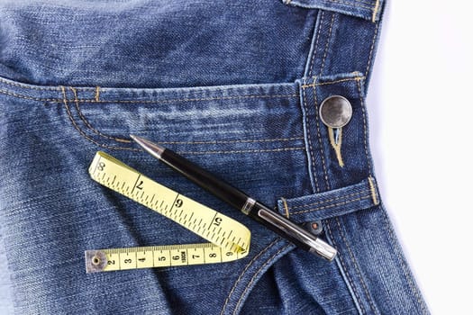 Pen and Measuring tape on front blue jeans