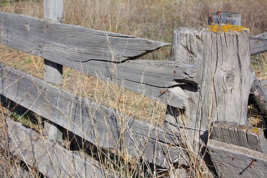 Old wooden fence and post with broken pieces
