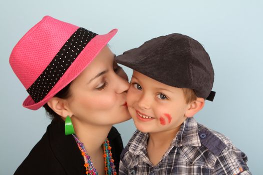 Brunette mother kissing her son on his cheek