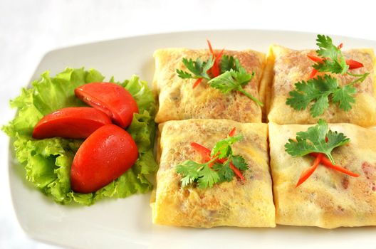 A delicious omelet with ham and tomato