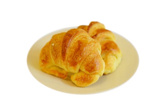 two fresh croissant ,casting soft whadow on white. 