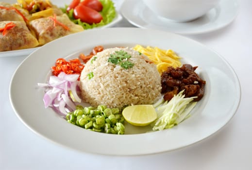 Mixed cooked rice with shrimp paste sauce and fresh vegetable , Thai food on table