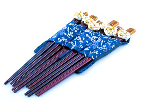 Six sets of Chinese chopsticks dark brown against a white background
