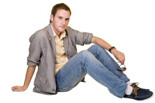 Portrait of a casual young man sitting relaxed. Isolated on white