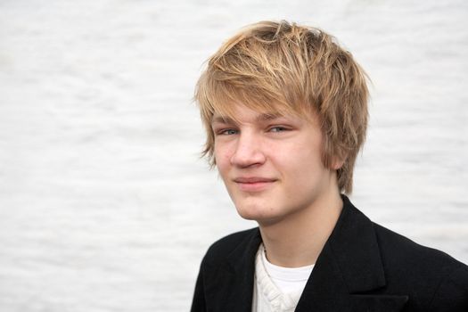 Portrait of smiling teenage boy looking at camera, horizontal