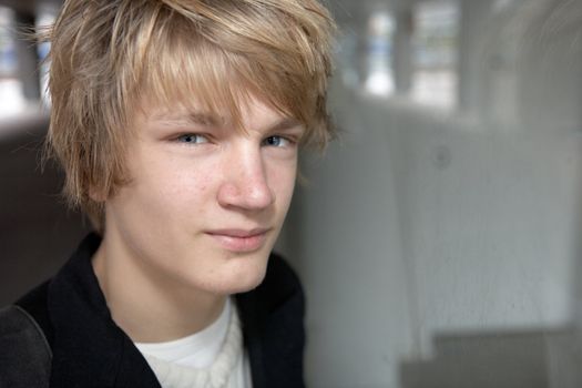 Portrait of teenage boy in city street, looking at camera