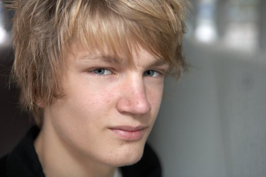 Close-up of teenage boy looking at camera, exterior
