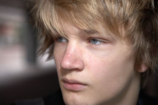 Teenage boy in city street looking away, close-up portrait