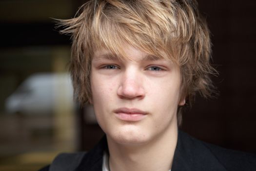 Teenage boy in urban location, horizontal close-up