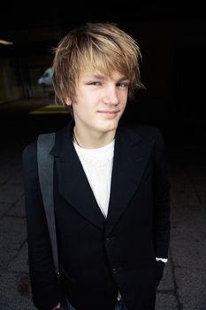 Portrait of teenage boy in street, smiling