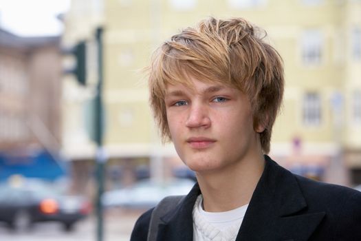 Portrait of teenage boy in street, looking at camera