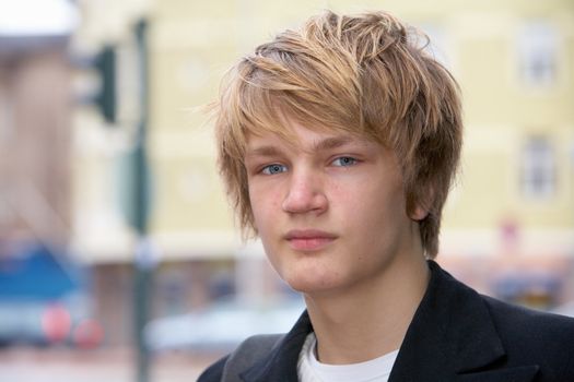 Portrait of teenage boy in street, close-up