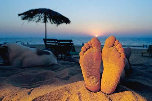 Woman is sunbathing on the sandy tropical beach