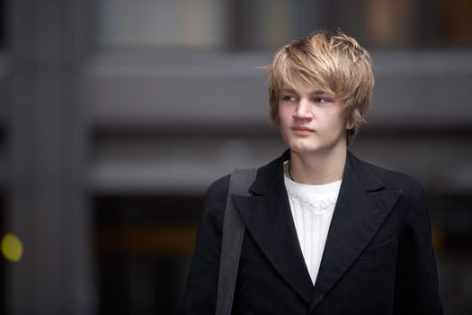 Portrait of teenage boy in street, copy space