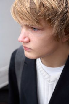 Portrait of teenage boy in street, high-angle close-up