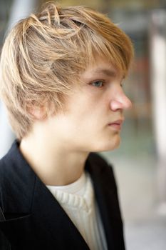 Side profile of teenage boy in urban environment, interior
