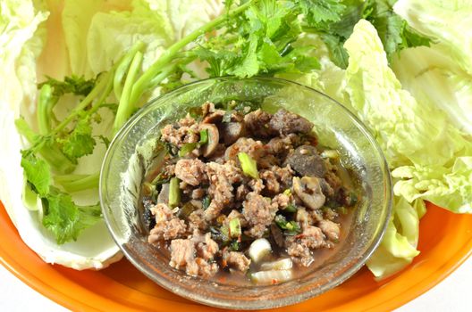 Thai dish of spicy minced pork eaten with vegetable